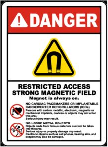 A danger sign with a red header saying danger. Underneath is a yellow triangle with a magnet symbol indicating a strong magnetic field.